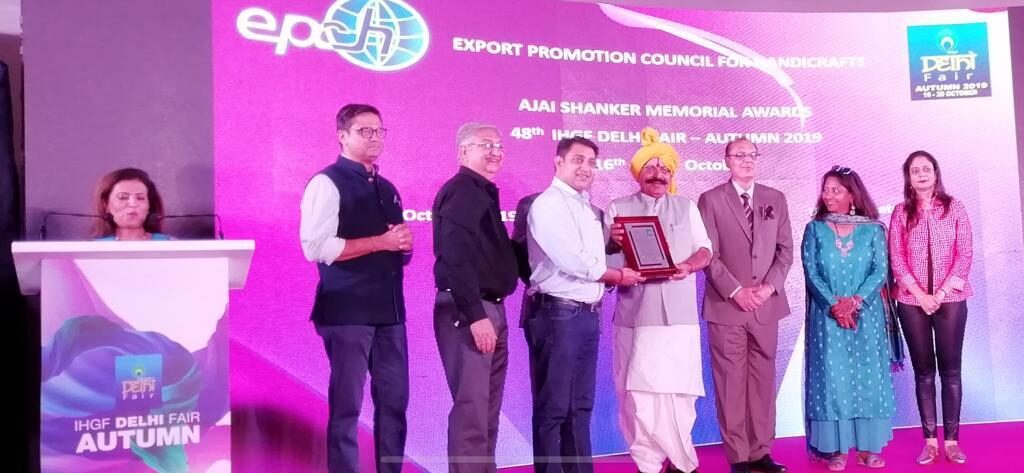 Sai Creation leadership receiving an EPCH award on stage